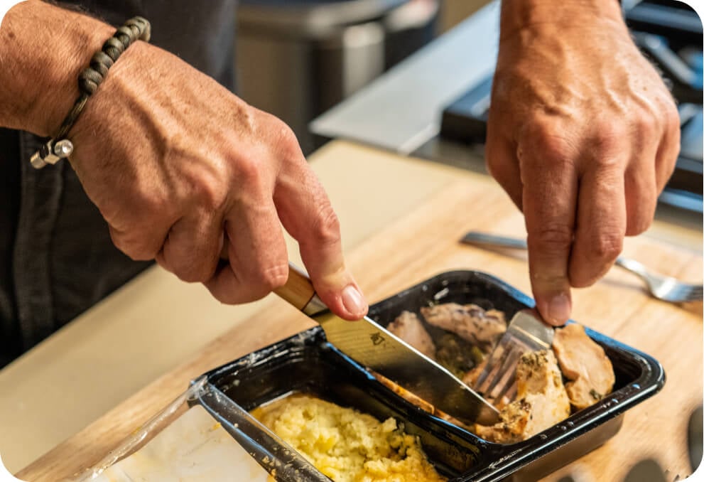 Todd English is cutting meat